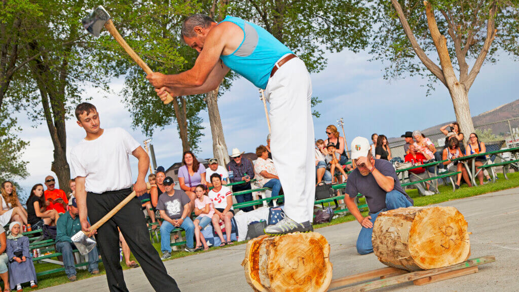man chopping wood at basque festival