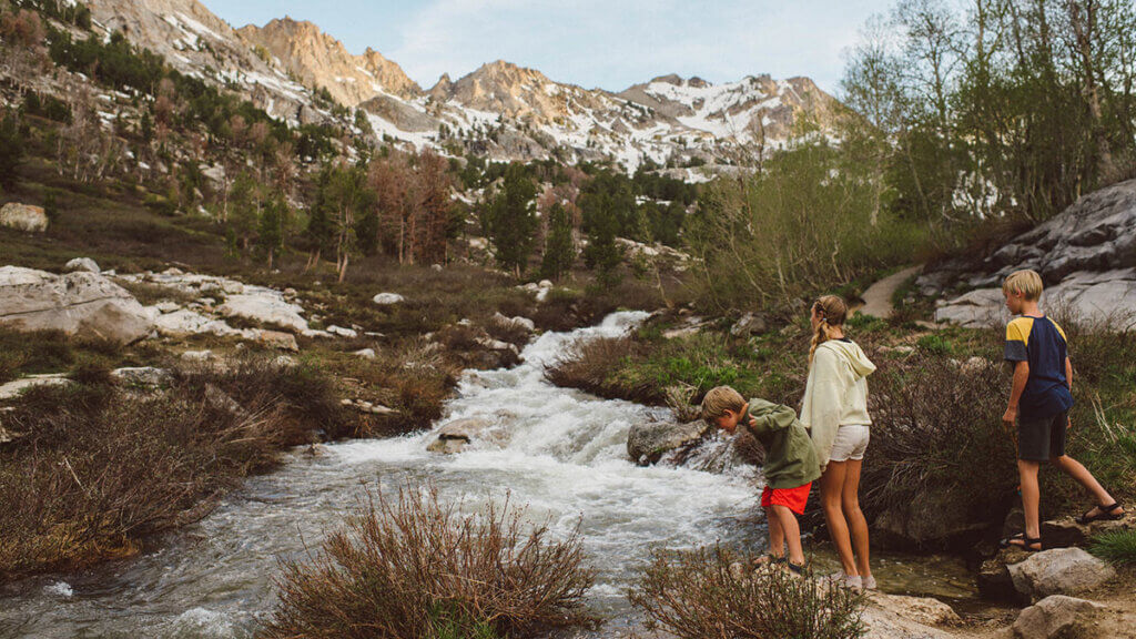 kids at a stream in lamoille canyon in nevada's ruby mountains