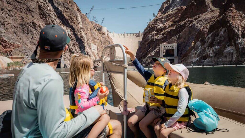 family on boat tour at hoover dam