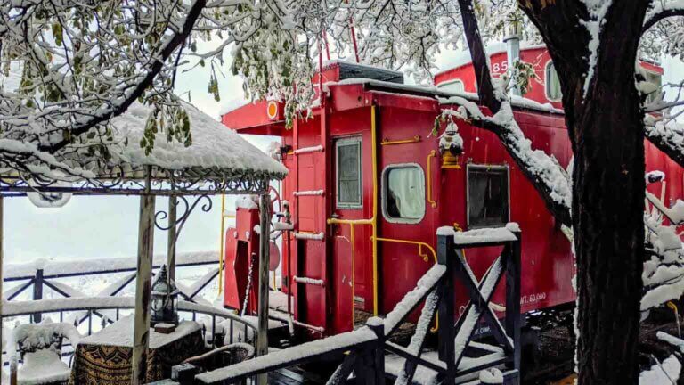 ruby caboose covered in snow