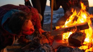 man by campfire
