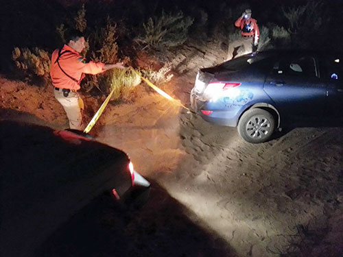 Search and rescue towing out a stuck passenger car