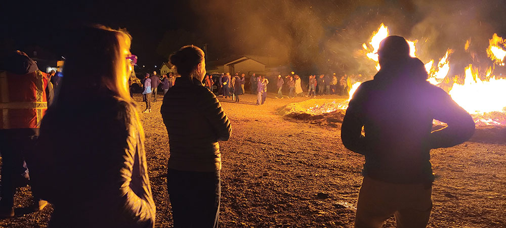 A crowd enjoys a bonfire in downtown Ely