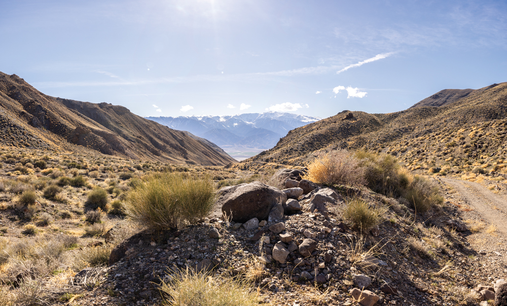 Panorama of the road up to McAfee Canyon and the White Mountains in the background.