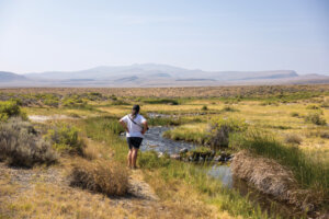 Woman standing in front of Soldier Meadows Hot Springs.