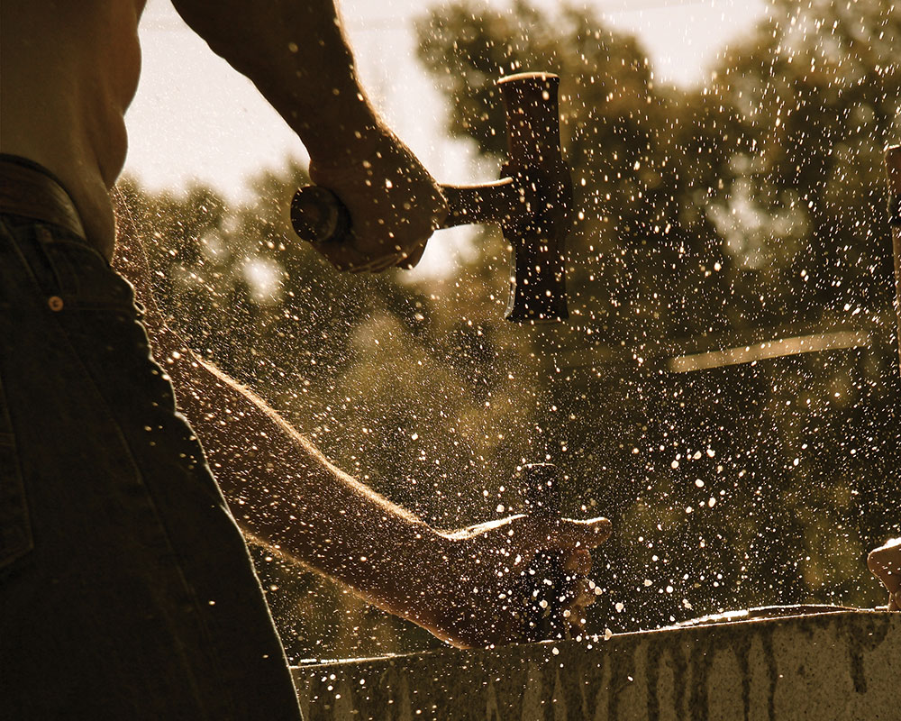 A man using a hammer.
