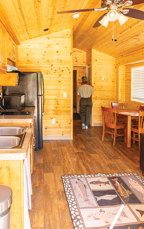 A person explores the inside of a cabin.