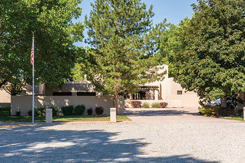 Walker River SRA Visitor Center. A pale colored adobe-style building, surrounded by trees.