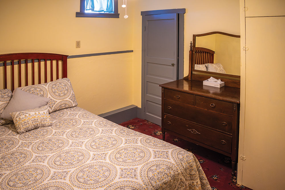 Inside of a room at Magnolia Gallery & Inn, bed, dresser, closet