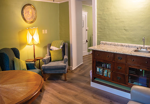 Inside of a room at Magnolia Gallery & Inn, sink, chairs, table
