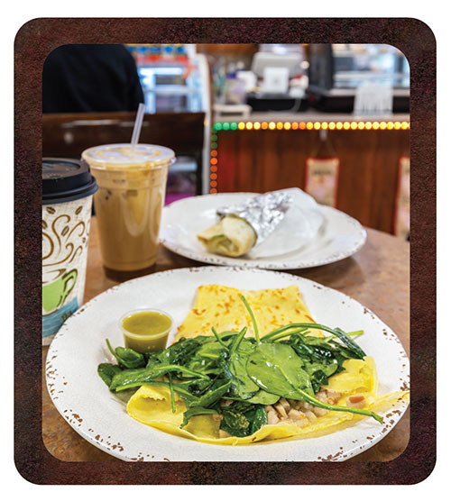 A couple to-go cups of coffee, and breakfast burrito and crepe