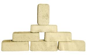 A historic picture of 7 gold bars stacked on top of each other.