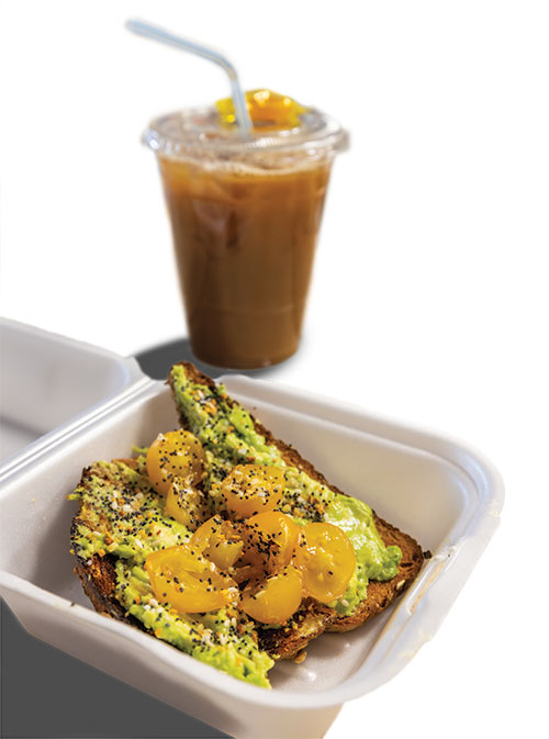 Avocado toast and an iced coffee with a butterscotch candy on top