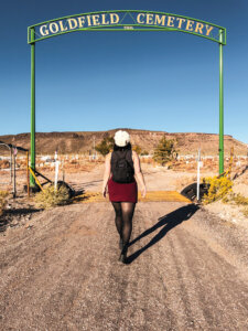 Woman walking into Goldfield Cemetery.