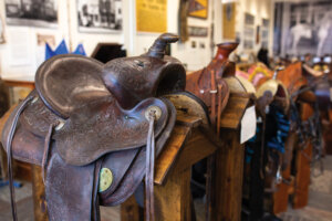 Display of cowboy saddles.