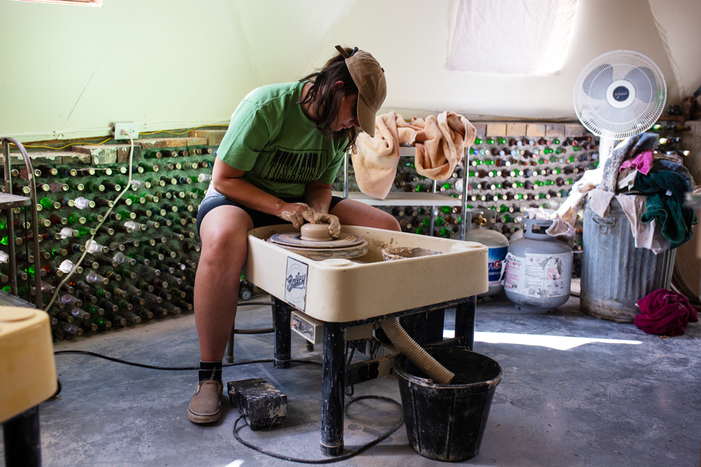 Girl throwing on a pottery wheel. 