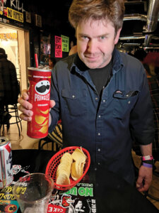 KJ Jansen from the band Chixdiggit holding a a popular drink sold at the Punk Rock Museum called 'Fletcher.'
