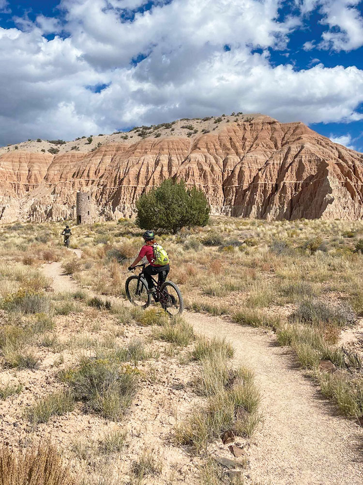 Two people ride bicycles along a dirt trail in Cathedral Gorge State Park