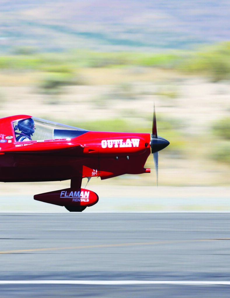Red aircraft flying low, labeled 