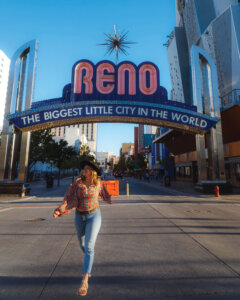 Woman walking in front of the Reno sign.