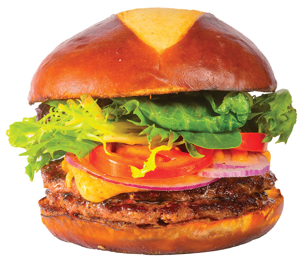A double-patty burger with cheese, onion, tomato, and lettuce
