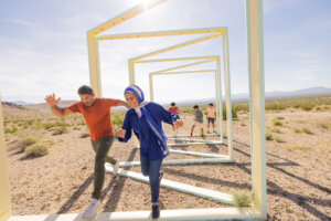 Family running through an art installation at the Goldwell Open Air Museum.