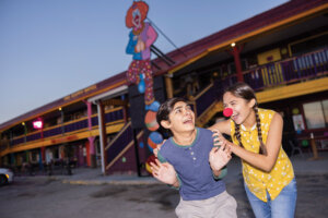 Girl wearing clown nose scaring her brother at the Clown Motel in Tonopah.