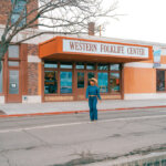 Woman walking in front of Western Folklife Center.