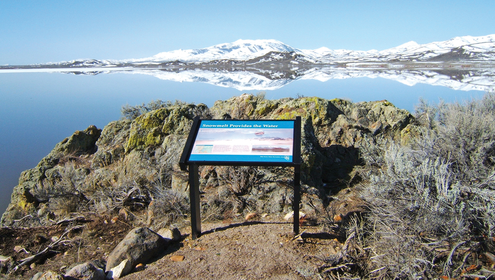 Informational guide next to a lake at Wild Horse State Recreation Area.