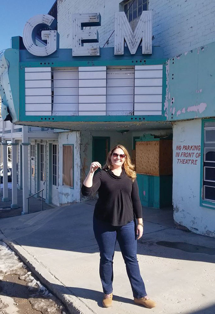Melissa Clary stands in front of Pioche's Gem Theater, with keys in her hand
