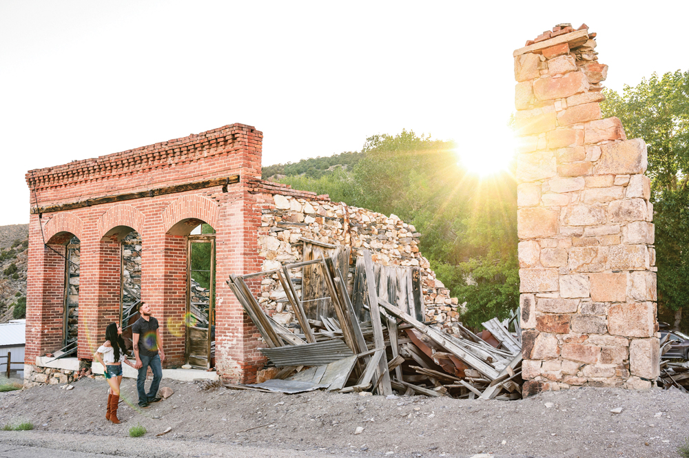 Man and woman stand next to an old run down building in Belmont.