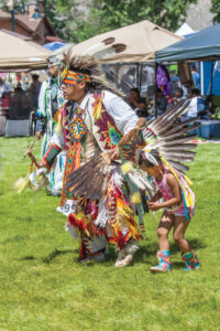 Man and child dancing at Stewart Father's Day Powwow.