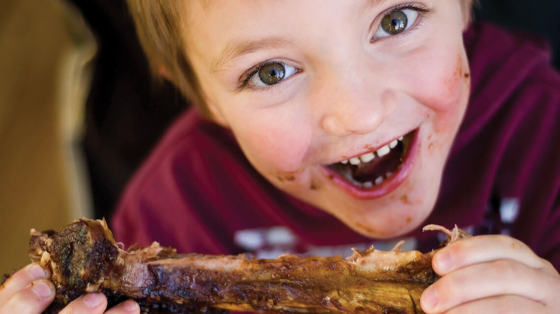 kid eating bbq ribs