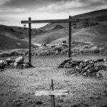 Black and white photo of an old cemetery in the desert.