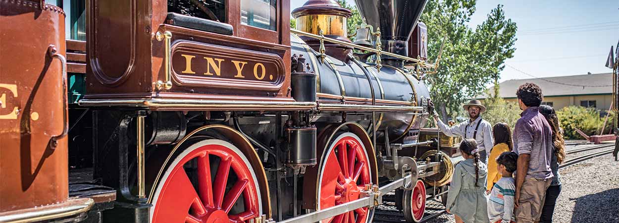 a family views a locomotive at the nevada state railroad museum