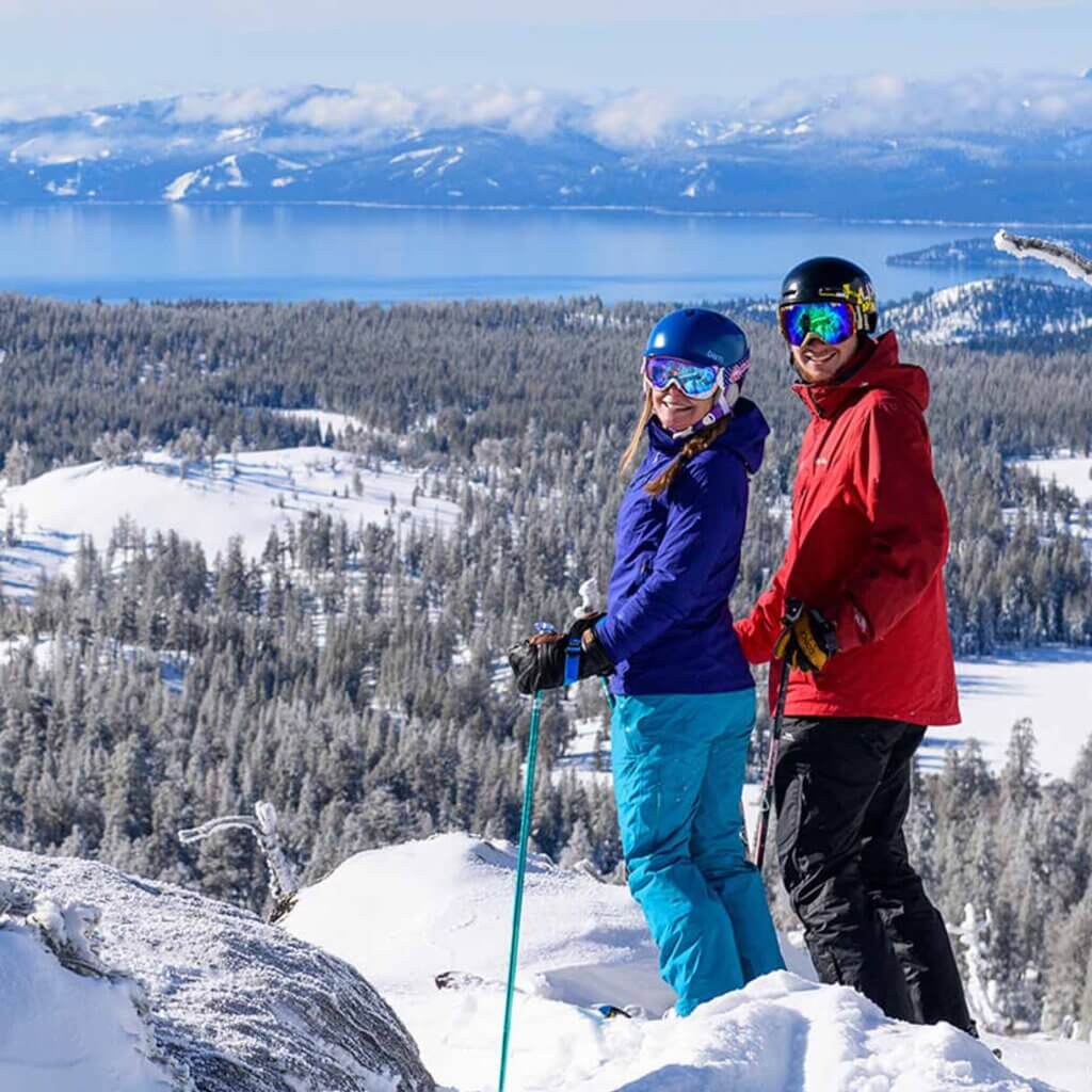couple atop mountain overlooking lake tahoe at mount rose ski resort