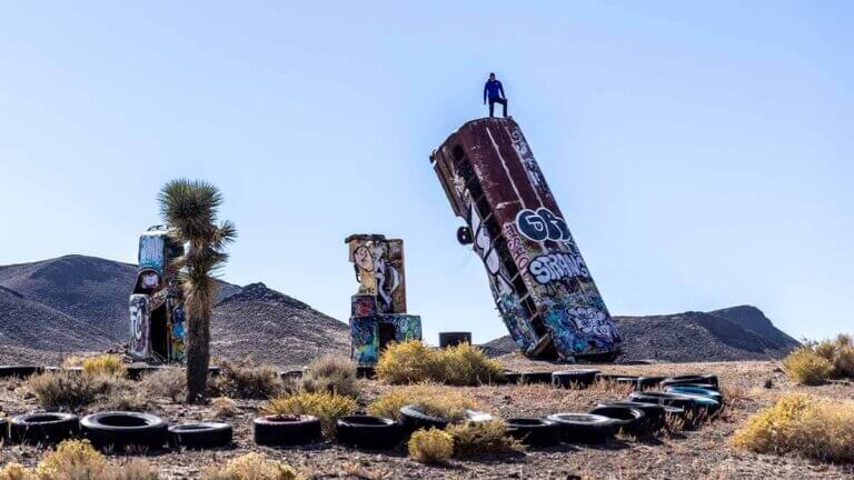 alex honnold atop bus at international car forest