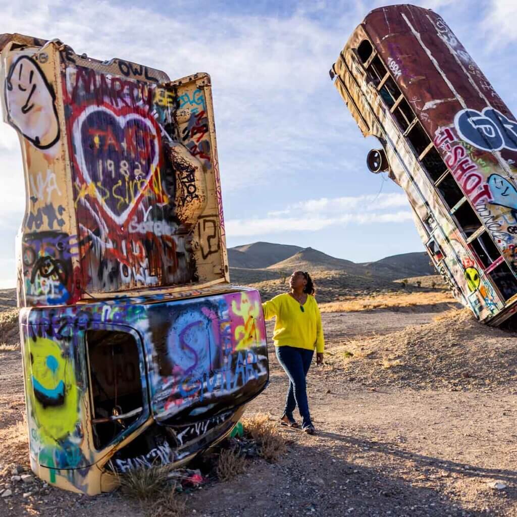 woman admiring vertical car at international car forest in nevada