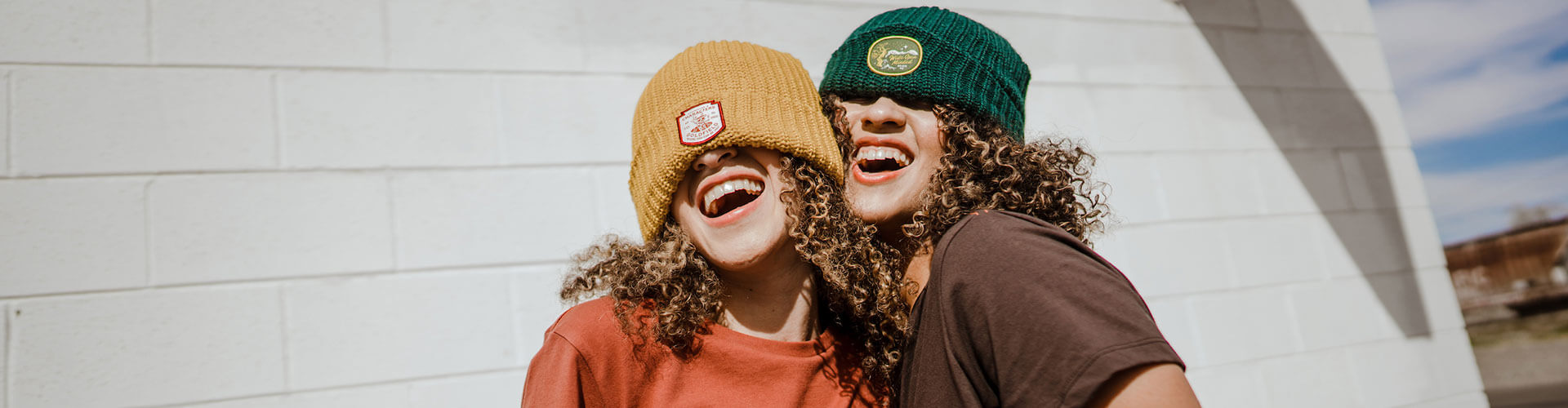 smiling gals wearing deso beanies and t-shirts in nevada