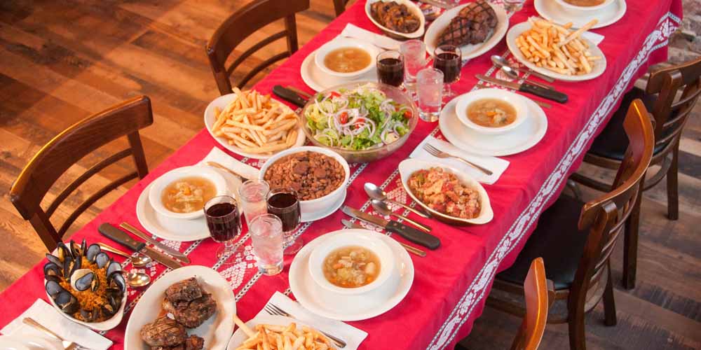 dining table covered with basque dishes from louis basque corner restaurant