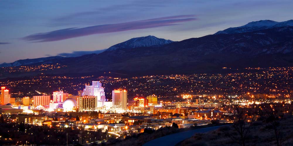 view of reno city light and mountain range at dusk