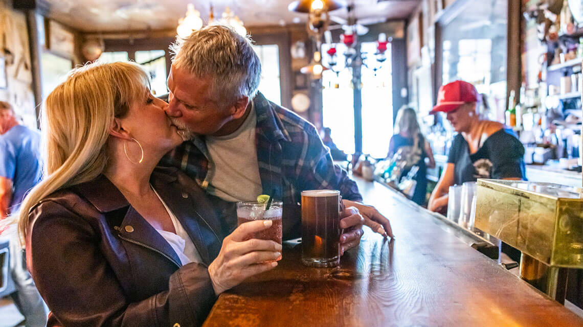 a couple kissing at the bar inside genoa bar and saloon in genoa nevada