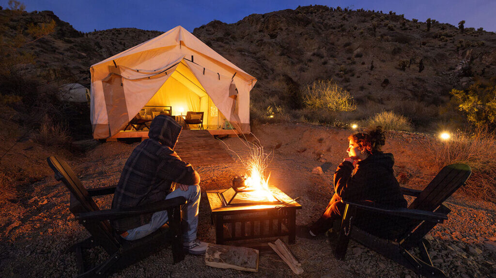 two people sitting by the fire at vegas glamping outside las vegas nevada