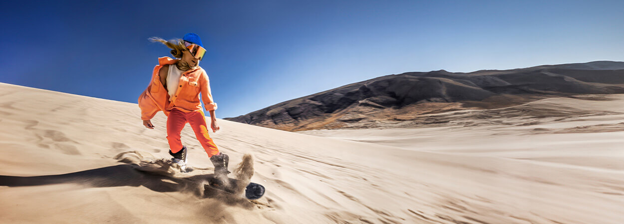 woman sandboarding at nevada sand dunes