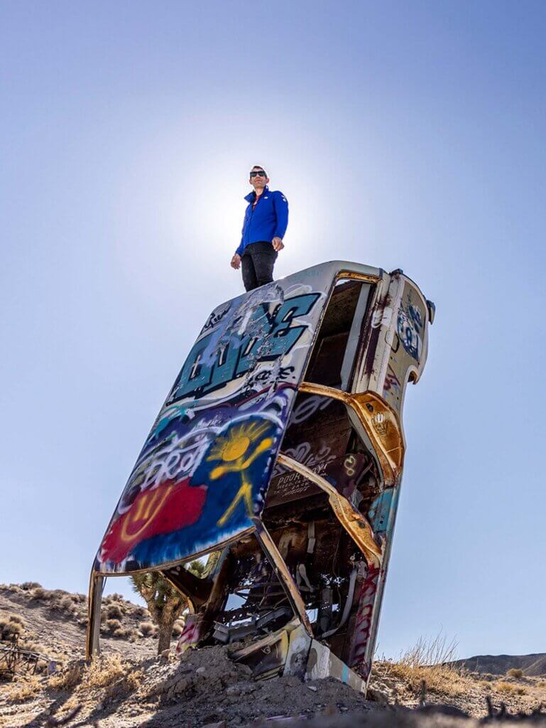 alex honnold atop car at nevada international car forest