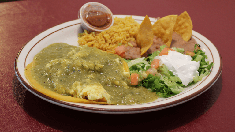 A plate from Strawberry Hill Diner shows rice, beans, lettuce, and an open taco.