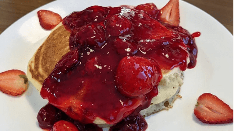 A plate from Strawberry Hill Diner shows pancakes top with a strawberry jam.
