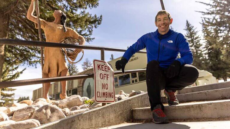 alex honnold posing by no climbing sign