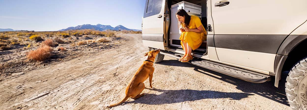 woman and dog van life in rural nevada