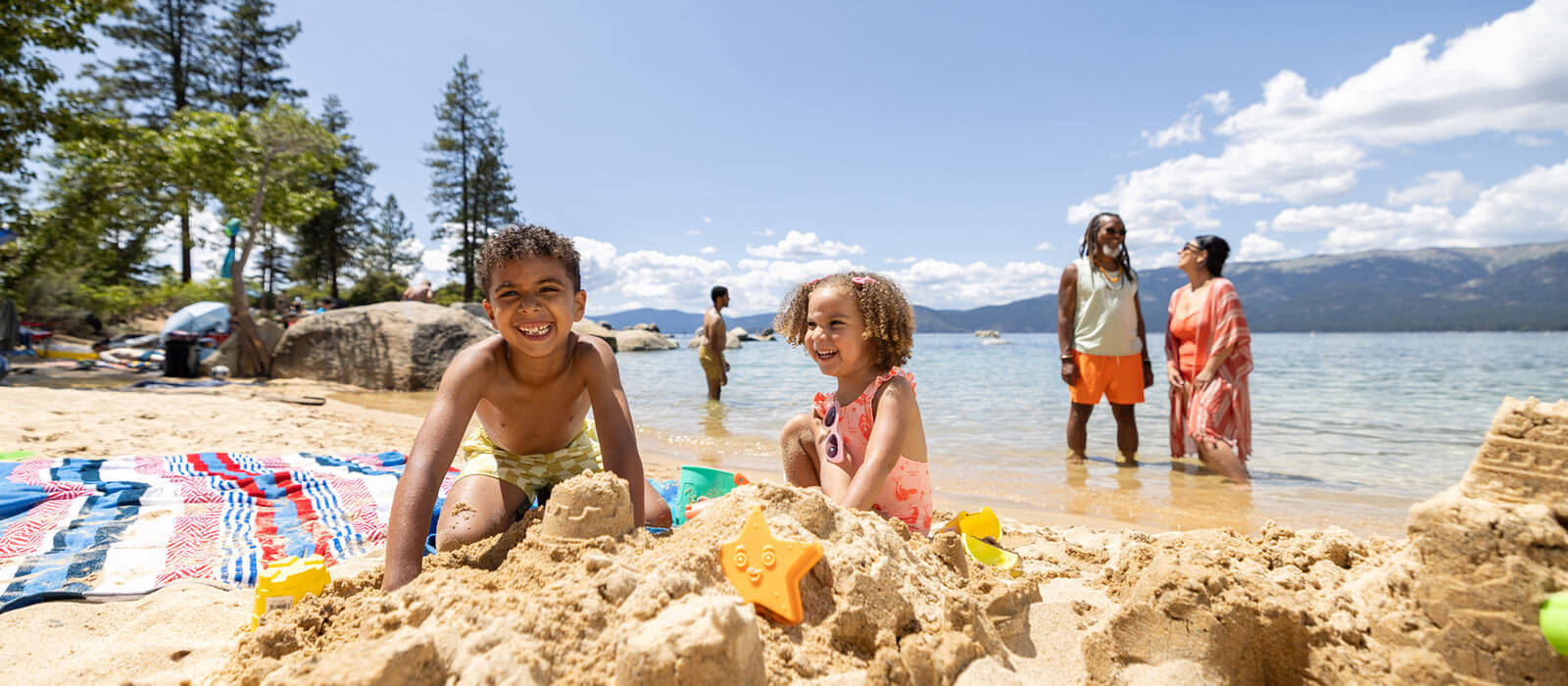 family playing on the beach at sand harbor state park in north lake tahoe nevada
